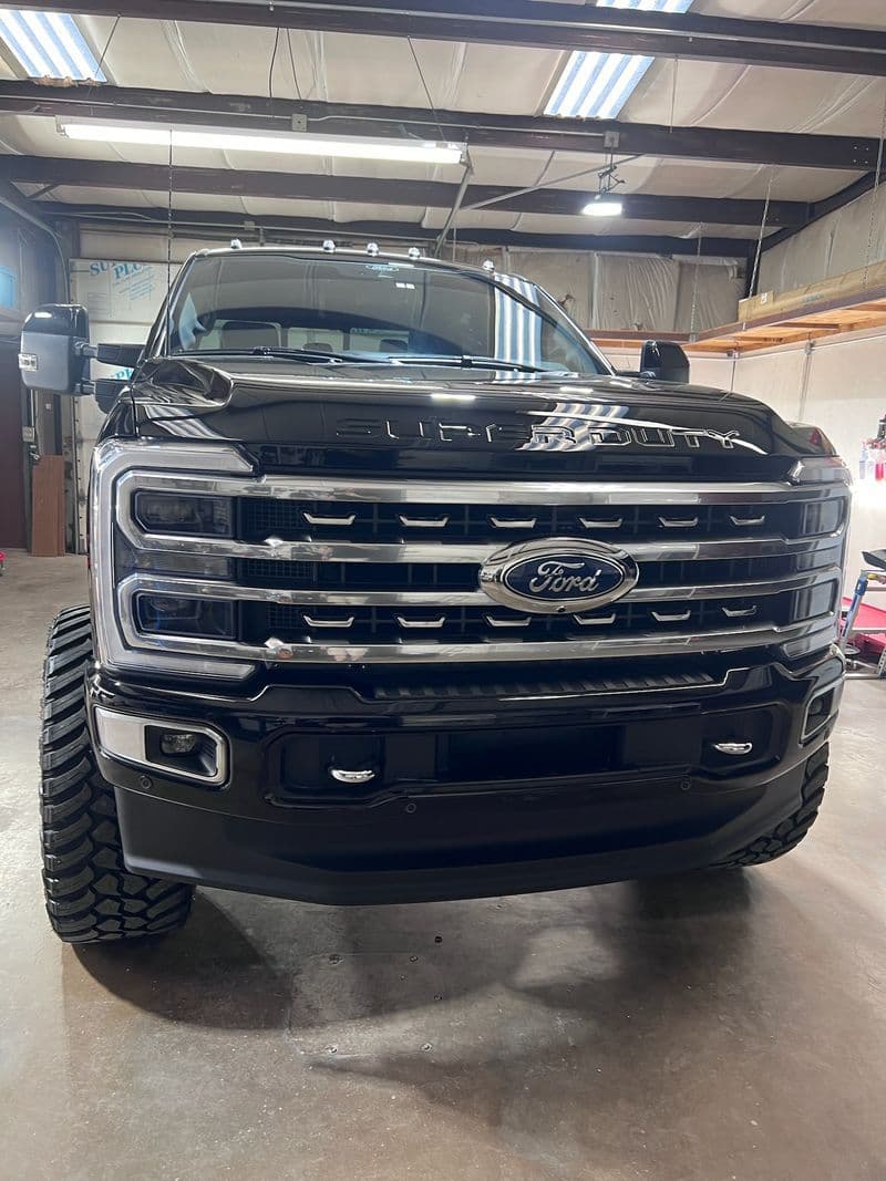 Close-up of a black Ford Super Duty truck grille after detailing at Grimeaway Autoworks
