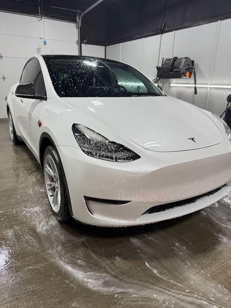 White Tesla Model Y getting foam-washed at Grimeaway Autoworks in Ada, OK